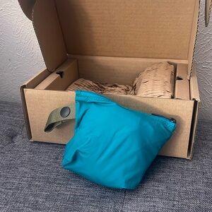 Away. The Packable Sling Bag. NWT. Teal. Over the shoulder bag. Inside pocket.